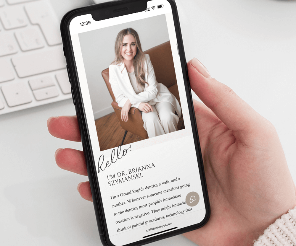 mockup-featuring-a-woman-s-hand-holding-an-iphone-11-pro-over-a-neat-desk-2158-el1